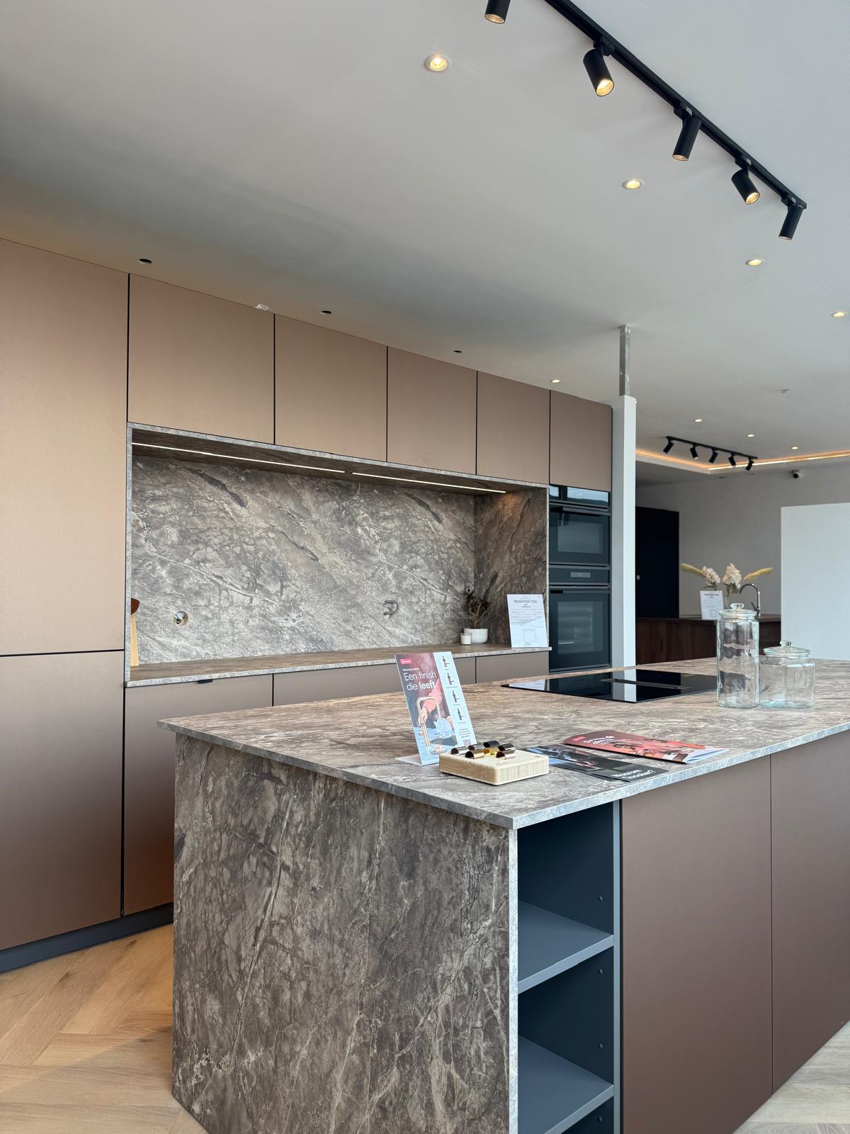 Keuken in bronstinten met marmeren eiland en nis